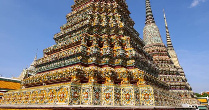 Close up view of Intricate architecture of historic Wat Pho temple against blue sky in Bangkok, Thailand