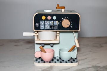 Wooden Toy Coffee Machine with Cups on Marble Background