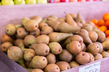 View of ripe pears in a wicker basket, put up for sale in a store