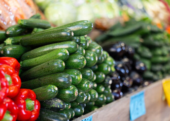 Green zucchini in shop window. Stocks of fruits in stores storage. Fresh fruit vegetable harvest from producer is already on store shelves.