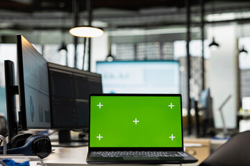 Empty corporate workspace features digital resources and mockup screen, space ready for report writing, strategy development and alignment of organizational objectives and goals achievement.