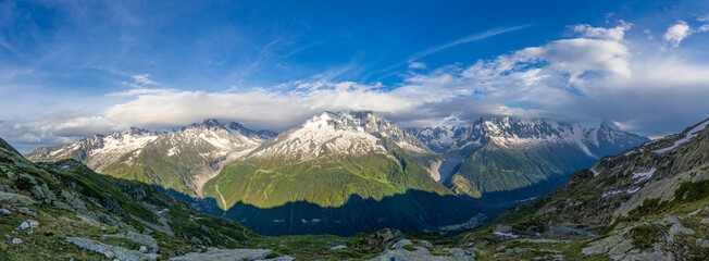 Panoramic mountain landscape in Chamonix with Mont Blanc massif, alpine peaks, glaciers, valleys, snow capped ridges, clear sky, European Alps scenery, natural terrain, high altitude environment area