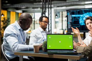 Green screen laptop used by startup manager showing investors how to leverage artificial intelligence technology. Silicon Valley company specialist presenting businessmen AI tech on mockup notebook