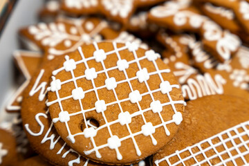 Close-up of beautifully decorated gingerbread cookies, featuring intricate icing designs, set against a blurred background. Ideal for festive marketing and holiday-themed promotions.
