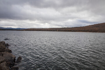 Cuerda del Pozo Reservoir, Vinuesa Reservoir full of water on a cloudy day