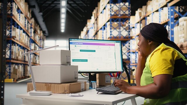African american overworked woman struggling to stay awake, dealing with burnout after a long shift of processing orders in industrial warehouse space. Exhausted staff member. Camera A.