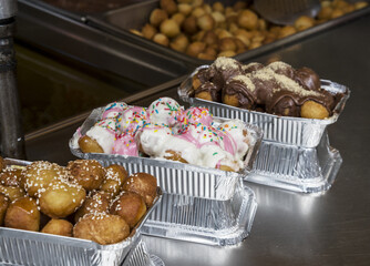 Greek Loukoumades donuts filled with chocolate, honey, and sesame seeds,