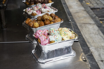 Greek Loukoumades donuts with fillings - honey and sesame, white fondant