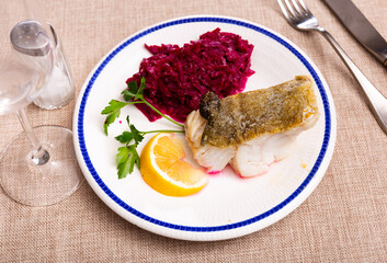 Fillet of white sea cod fish is fried in batter, garnished with grated stewed beetroot salad. Fish...