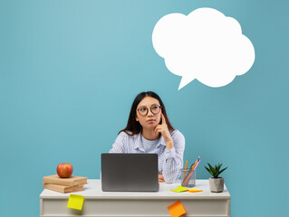 A woman is seated at her desk with a laptop in front of her. She appears deep in thought, surrounded by books, an apple, and colorful sticky notes, with a blank speech bubble above.