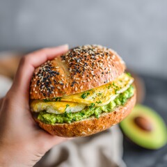 Hand holding a freshly made breakfast sandwich