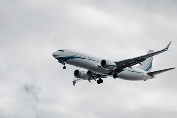 Airplane flying through cloudy sky, showcasing sleek design and aerodynamic features, representing modern aviation technology and travel innovation