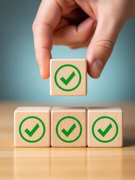 success concept Hand placing wooden block with green checkmark symbol for approval or success