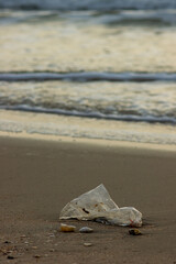 Plastic Waste Scattered on Beach Sand. Plastic waste on beaches is a serious global problem.