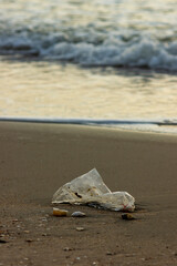 Plastic Waste Scattered on Beach Sand. Plastic waste on beaches is a serious global problem.