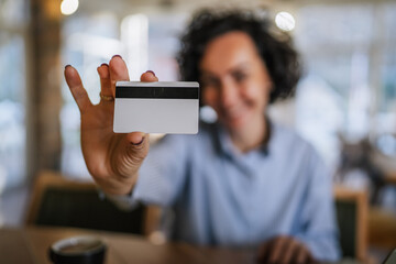 Woman showing credit card for secure online payment