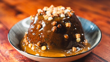 Beautiful chocolate pudding with rich fudge sauce, topped with small fudge pieces. Perfect for Christmas and year-end parties, a decadent and festive dessert everyone will love.