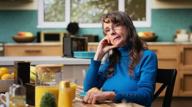 Fed up detached wife showing discomfort and boredom due to retired life monotony, husband always talking and exasperating her. Realistic marriage moment indoors, displeasure. Camera B.