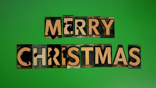 Vintage letter blocks spelling out 'Merry Christmas' on a vibrant green background, celebrating the festive holiday season.