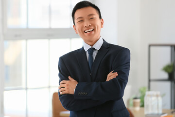 Fototapeta premium Portrait of smiling Chinese businessman in office