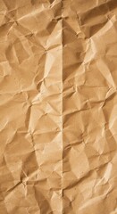 A top-down view of heavily crumpled brown kraft paper showcasing its intricate texture, numerous folds, and deep creases with natural lighting and subtle shadows.