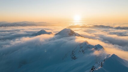 Snow-capped mountain peaks rising above a sea of clouds at sunrise
