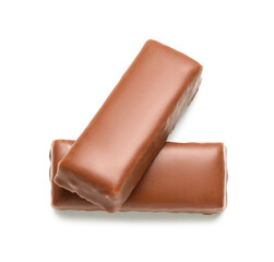 Tasty chocolate covered coconut candies on white background