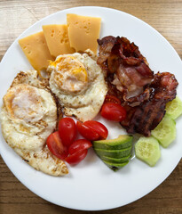 Delicious Assortment Of Breakfast Items Including Eggs Bacon Cheese And Fresh Produce For Morning Enjoyment