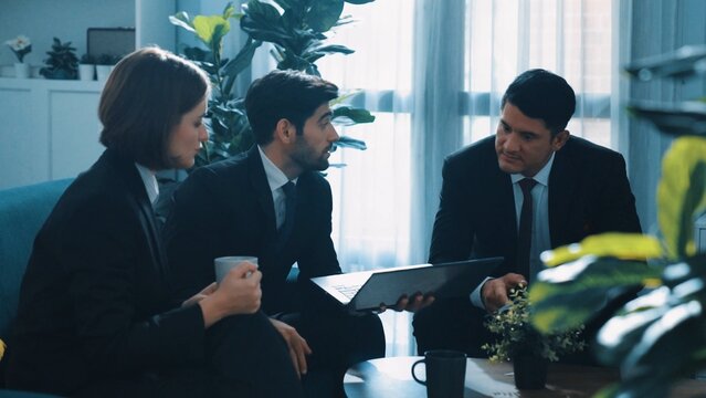 Time lapse of businessman working on laptop while share marketing idea with diverse colleague. Multicultural business people discuss about financial plan while sitting at meeting room. Directorate. - Powered by Adobe