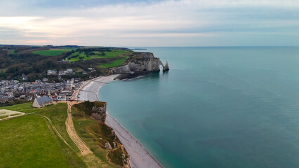 Aerial drone view of picturesque coastal limestone cliffs and the English Channel town of Etretat, France