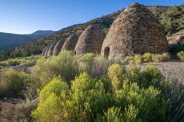 Historical Conical Stone Wildrose Kilns Against Desert Mountain Backdrop
