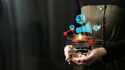 Woman holding shopping cart with blue megaphone and percentage discount icons.