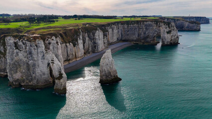 Aerial drone view of picturesque coastal limestone cliffs and the English Channel town of Etretat, France