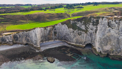 Aerial drone view of picturesque coastal limestone cliffs and the English Channel town of Etretat, France