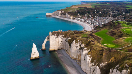 Aerial drone view of picturesque coastal limestone cliffs and the English Channel town of Etretat, France