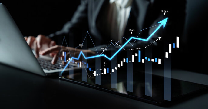A business professional works on a laptop, analyzing financial data with emerging graphs to illustrate growth. Innovative trends show market successes and investment potential. Scalp