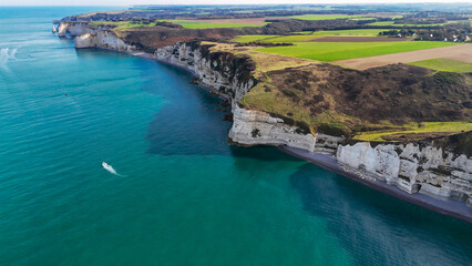 Aerial drone view of picturesque coastal limestone cliffs and the English Channel town of Etretat, France