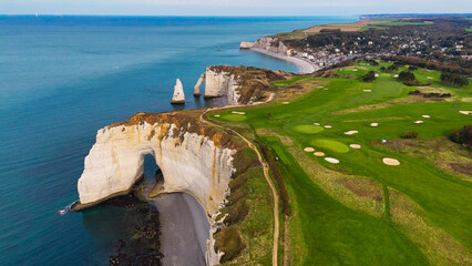Aerial drone view of picturesque coastal limestone cliffs and the English Channel town of Etretat, France