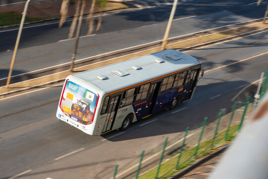 Public transport bus driving on highway top view, Urban transit vehicle panning shot