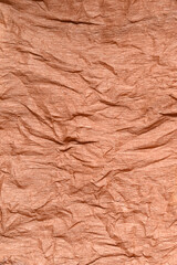 vertical textured background of crumpled brown crepe paper