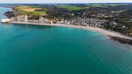 Aerial drone view of picturesque coastal limestone cliffs and the English Channel town of Etretat, France
