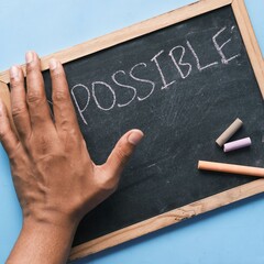 The picture shows a blackboard with the word 'Possible' written on it.
