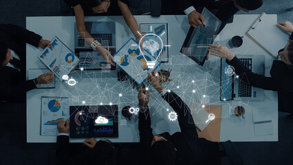 A dynamic business team collaborates on data analysis and strategy development in a modern office environment, utilizing technology and digital graphics for enhanced insights. Trope