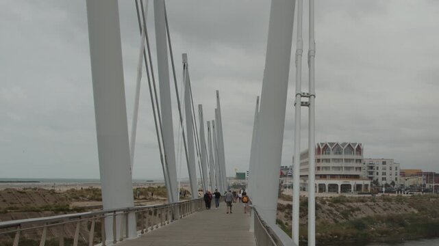 People Walking on Modern Bridge in Dunkirk, France