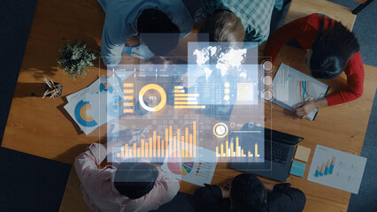A diverse team engages in data analysis and strategy discussions using modern charts and graphs in a collaborative workspace, driving innovation and insights. Scalp