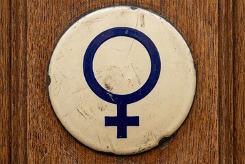 Symbol of Feminism on a Wooden Door