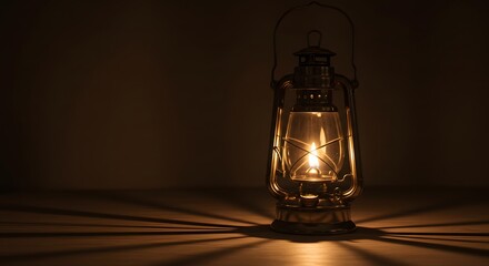 Lit lantern on a table casts shadows against a dark background