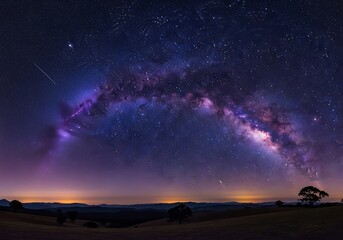 A breathtaking panoramic view of the milky way galaxy shimmering above a dark mountain landscape