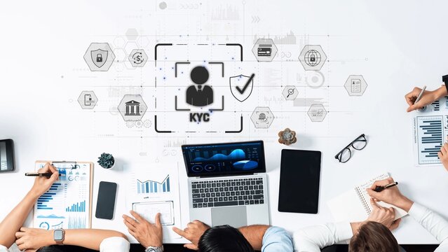 A diverse team collaborates in a modern workspace, focusing on KYC compliance using technology, data analysis, and financial management tools for effective outcomes. Raster - Powered by Adobe