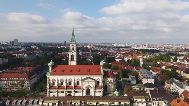 Aerial view passing the Church of the Holy Spirit, sunny day in Munich, Germany